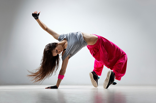 young and beautiful dancer posing in studio