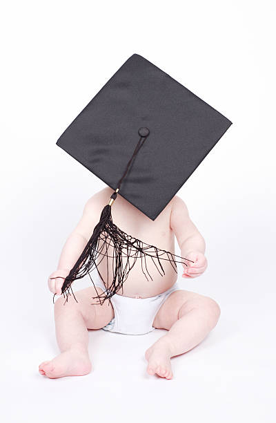 Young boy wearing graduation cap stock photo