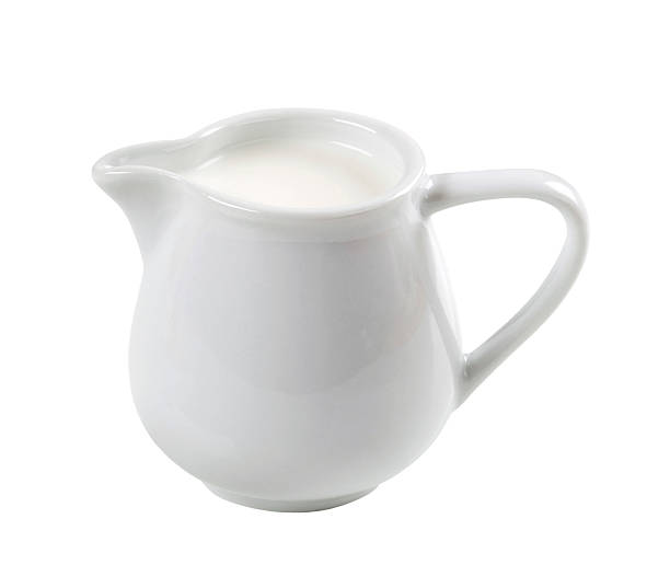 White jug filled with fresh milk Jug of fresh milk isolated on white background milk jug stock pictures, royalty-free photos & images