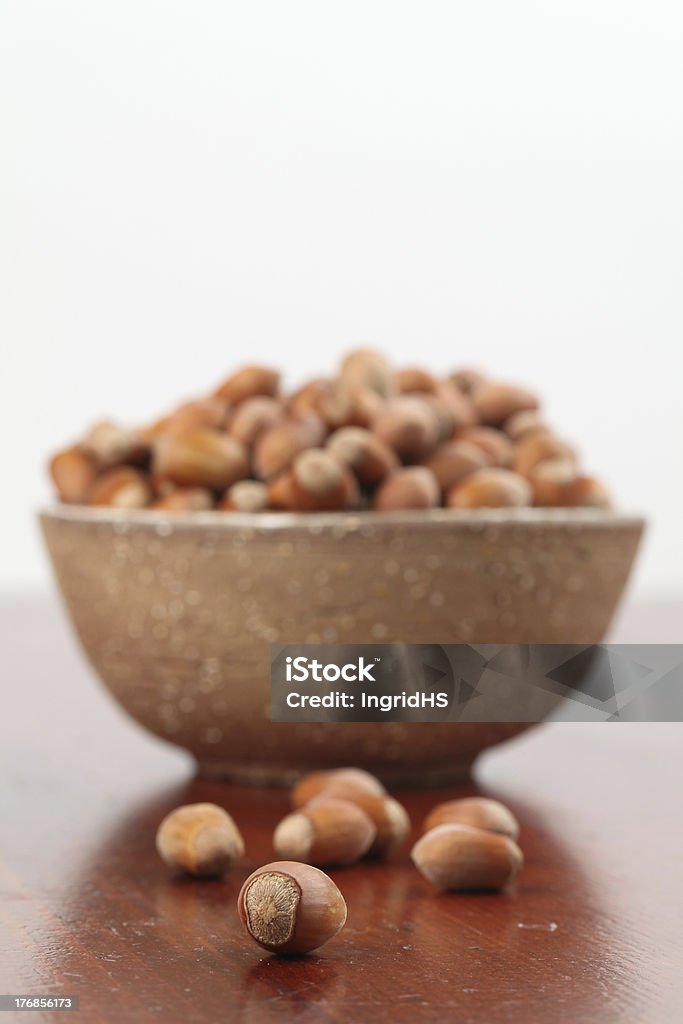 Hazelnuts Bowl with hazelnuts on a wooden table. Shallow DOF Bowl Stock Photo