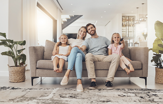 Home, portrait and family with girls on a couch, relax and happiness with weekend break, calm and support. Children, mother and father with kids, resting and smile with care and cheerful in a lounge