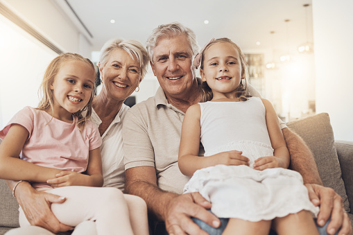 Smile, grandparents and kids in portrait in home living room, support and bonding together. Happy children, grandmother and grandfather on sofa for connection, love and family in healthy relationship