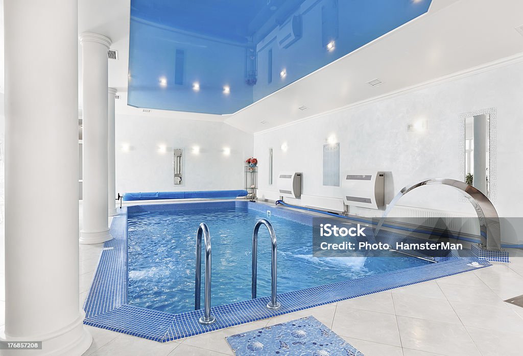 Indoor big blue swimming pool interior in modern style Indoor big blue swimming pool interior in modern minimalism style.To see more Interior photos please click on the link below: Architectural Column Stock Photo