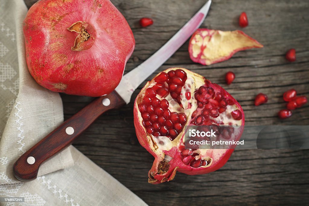 Pomegranate Juicy riped pomegranate  and knife on the wooden table Close-up Stock Photo