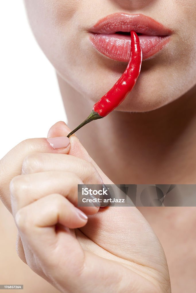 Young woman with chili pepper isolated on white Adult Stock Photo