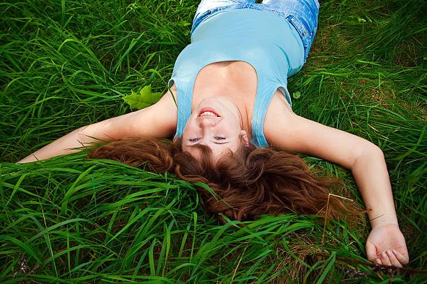 istock Laughing Woman On A Grass 176857401