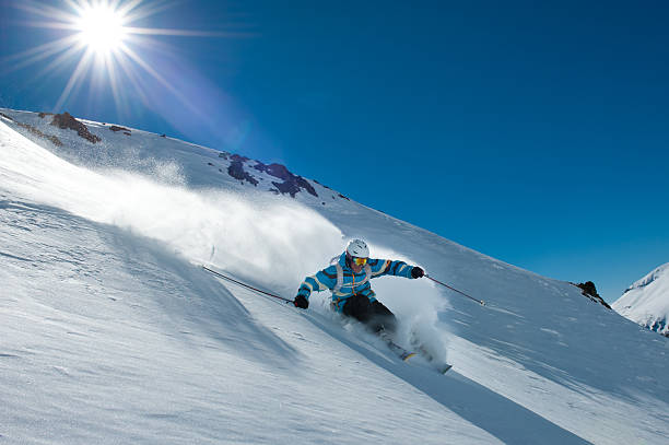 istock Skier and sun on the snowy mountains 176857420