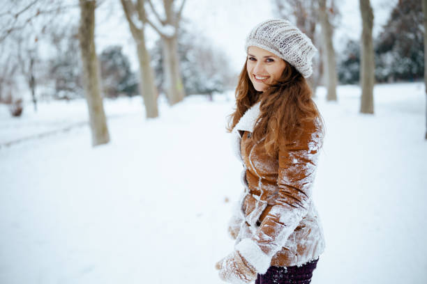 istock smiling elegant woman shaking snow off clothes 1768574491