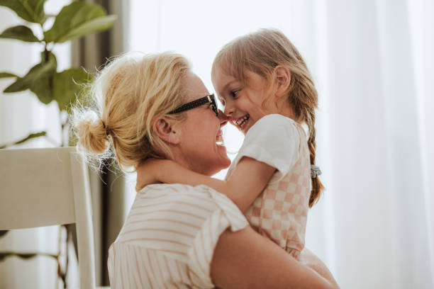 istock Cheerful Mom Embracing Her Cute Daughter At Home 1768580209