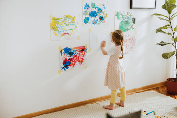 istock Unrecognizable Girl Drawing On Papers At The Nursery Wall 1768580210