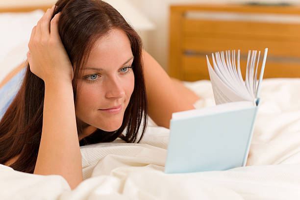 istock Bedroom - young woman read book in bed 176858146
