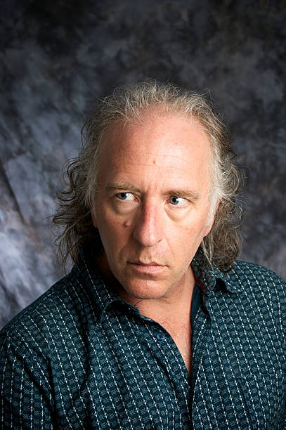 istock portrait of man in studio looking to the side 176858347