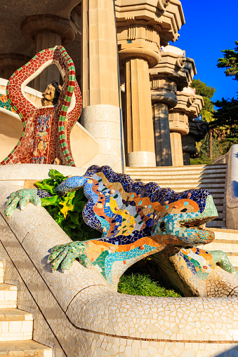 Barcelona, Spain - December 16, 2022: Multicolored mosaic dragon salamander of Gaudi in Park Guell, Barcelona, Spain
