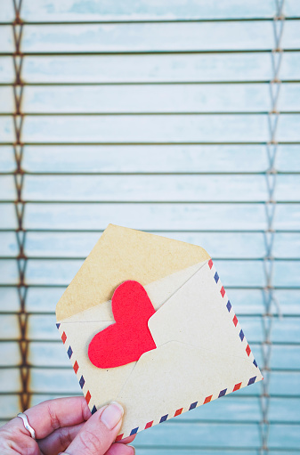 Red heart inside an old envelope