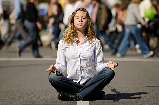 istock woman meditating on the street 176859749