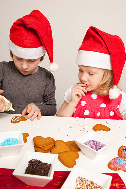 istock Girls decorating gingerbread cookies 176859841