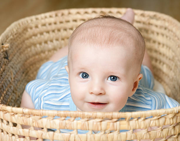 istock Little boy lying in wicker basket 176859962
