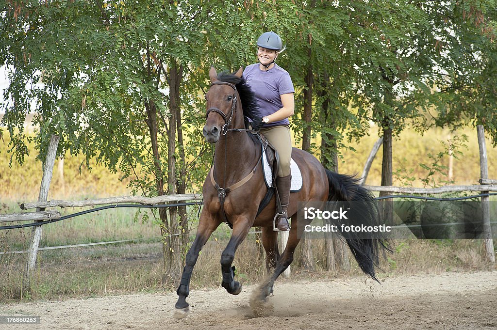 riding happy young woman riding horse Helmet Stock Photo