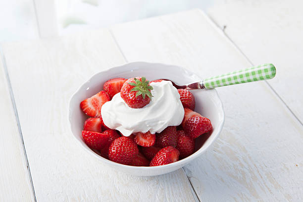 Strawberries with whipped cream stock photo