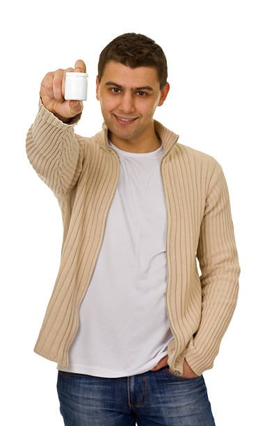 istock man holding a bottle of medicine 176860616