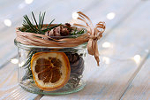 Christmas natural fragrant decoration in jar on wooden planks