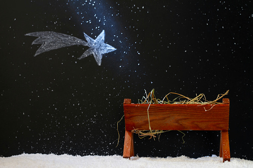 Manger and star of Bethlehem on snowy night, abstract christmas nativity scene concept creative