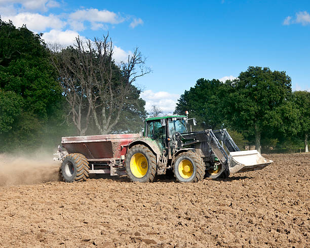 istock Tractor Fertilising Field Front View 176861071