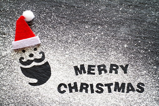 Santa Claus made of flour in red hat on black background, Merry Christmas lettering, creative christmas background concept