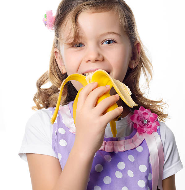 istock girl eating banana 176861563
