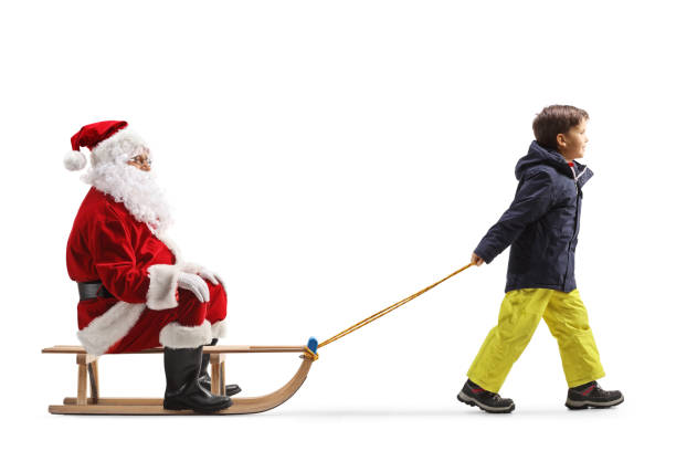 istock Boy in winter clothes pulling santa on a sled 1768616602