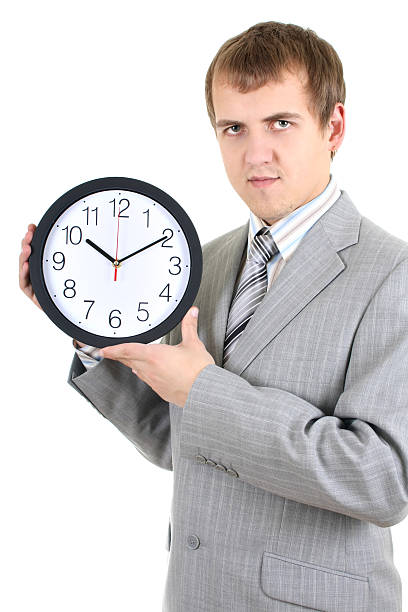 istock young businessman holding a clock 176861787
