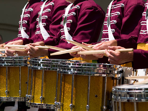 Drums A line of drum corp drums. Sticks in motion. drum line stock pictures, royalty-free photos & images