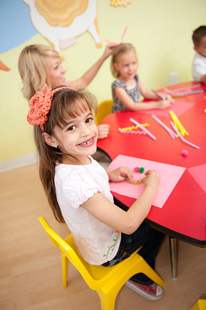 istock Schoolgirl smiling during arts and crafts 176862461
