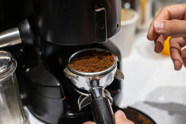 istock Close up of a coffee machine pouring ground coffee into a cup. 1768625083