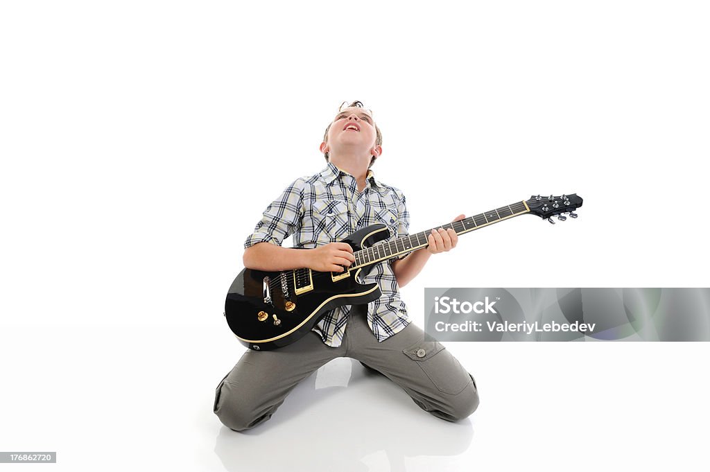 Little musician playing guitar Little musician playing guitar. Isolated on a white background Guitarist Stock Photo