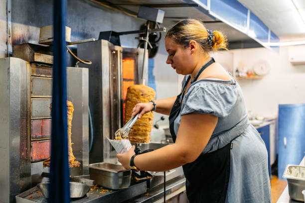 istock Food Service Worker Preparing Gyros At A Diner 1768628361
