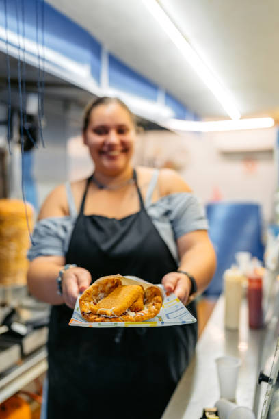 istock Food Service Worker Holding A Plate With Fried Cheese At A Diner 1768629399