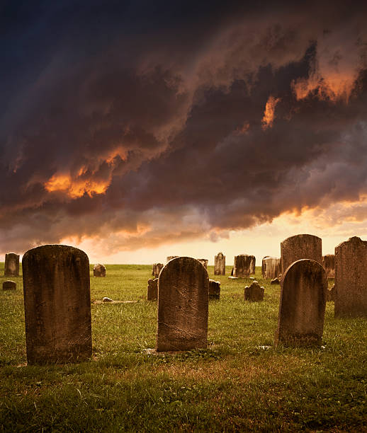 Old cemetery tombstones with spooky clouds