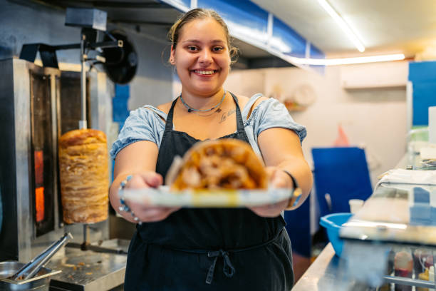 istock Food Service Worker Holding A Plate With Gyros At A Diner 1768631065