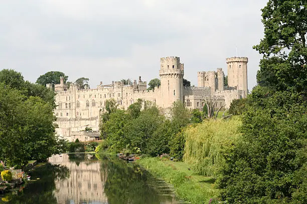 The famous Warwick Castle and its reflection in the still waters of the River Avon. A major tourist attracion and quintisential English view.