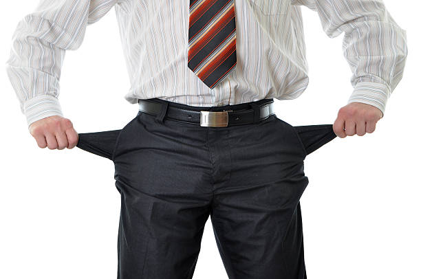 istock Businessman with empty pockets isolated on white 176863360