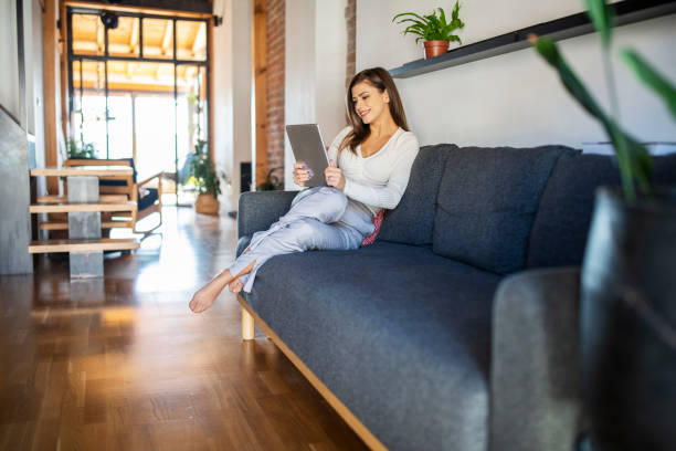 istock Woman online banking at home with a mobile device. 1768635473