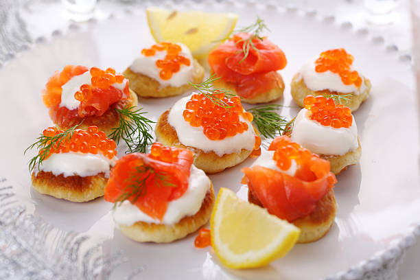 istock Holiday appetizer with caviar and salmon on white plate, 176863839