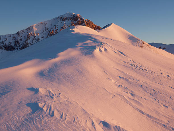 Snowy mountain at sunrise stock photo