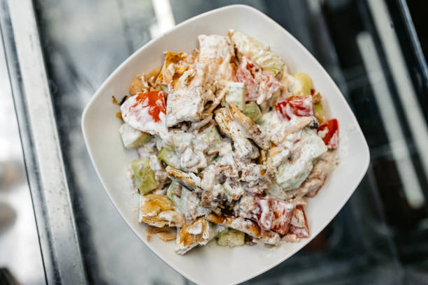 Fresh salad with gyros meat ready to eat on a plate at a diner