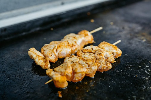 Shish kebabs being grilled at a diner.