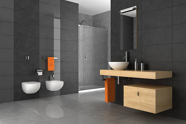 A tiled bathroom with a wood counter and orange towels