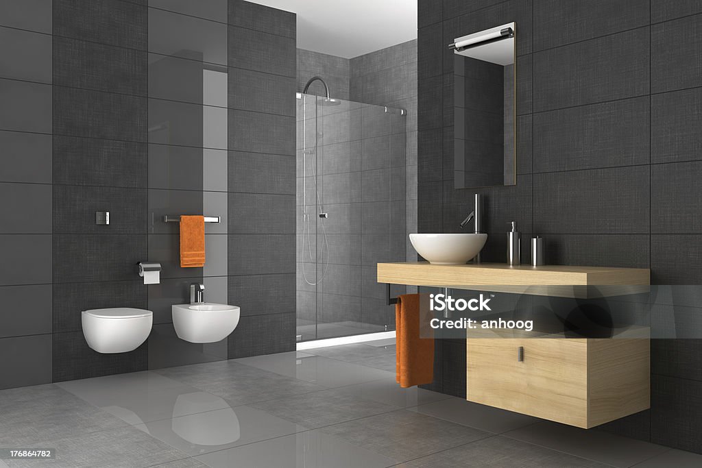 A tiled bathroom with a wood counter and orange towels tiled bathroom with wood furniture Bathroom Stock Photo