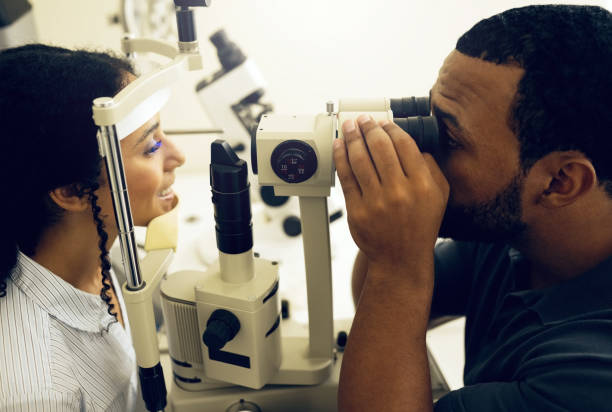 istock Eye test, machine and a woman with a doctor for a service, vision problem and surgery on lens. Happy, clinic and a patient with a man or optometrist for a medical exam, retina health and check 1768648812