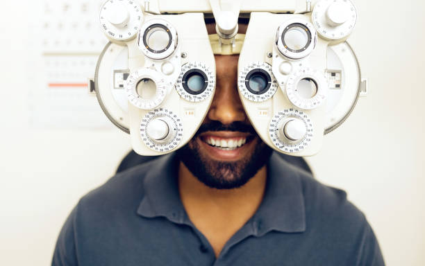 istock Eye test, face or happy man consulting to help eyesight at optometrist for a optical assessment. Optometry, wellness or customer in clinic for vision, iris or retina health with machine or phoropter 1768648832